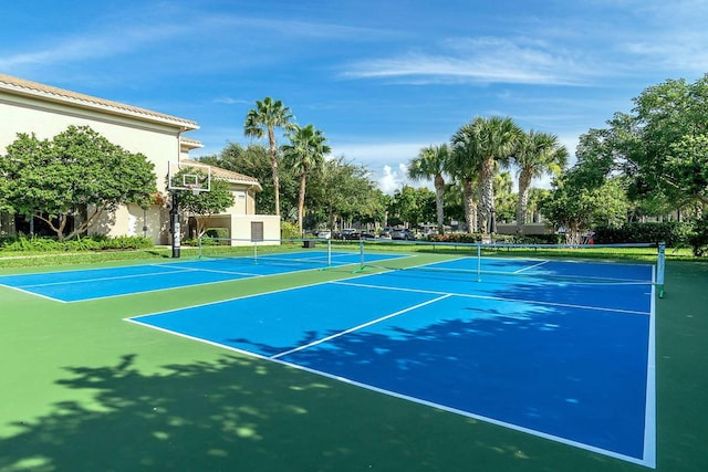 view of tennis court with basketball hoop