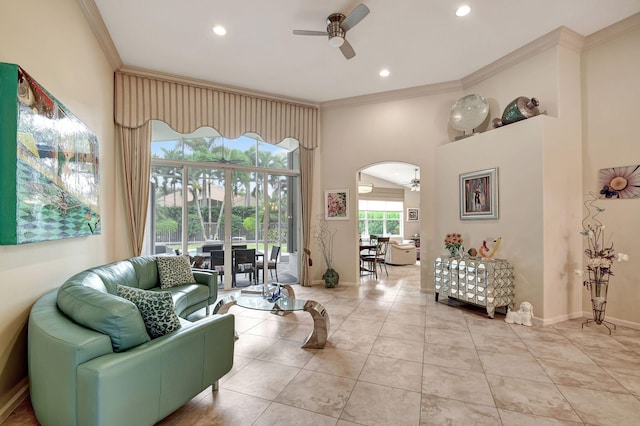 living room featuring ceiling fan, crown molding, and light tile patterned floors