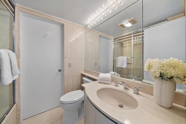 full bathroom with tile patterned floors, vanity, toilet, and combined bath / shower with glass door