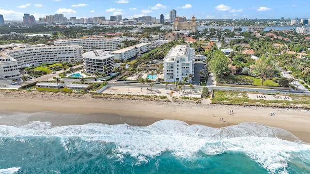 bird's eye view with a water view and a beach view