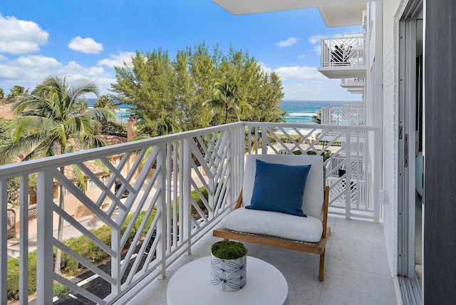 balcony with a water view and a beach view