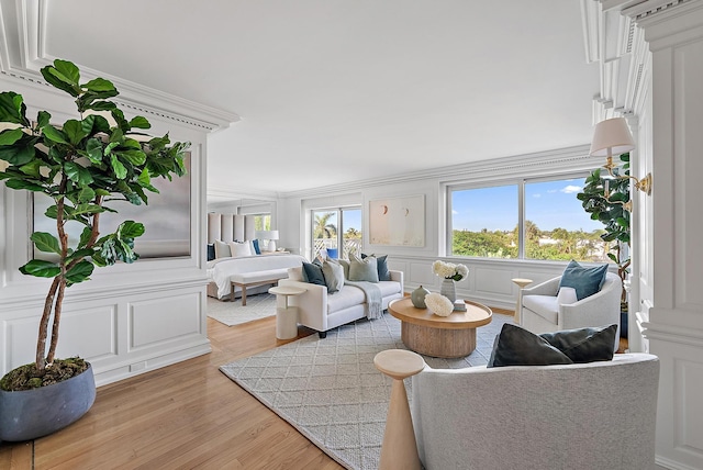 living room featuring light wood-type flooring and crown molding