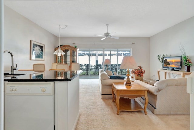 carpeted living room with ceiling fan and sink