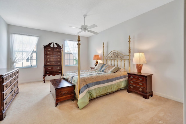 bedroom featuring light colored carpet, multiple windows, and ceiling fan