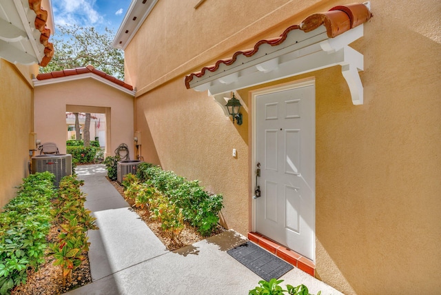 property entrance featuring central AC unit