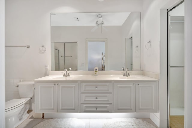 bathroom featuring tile patterned flooring, vanity, toilet, and ceiling fan