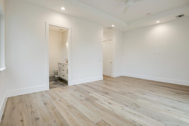 spare room featuring ceiling fan and light hardwood / wood-style floors