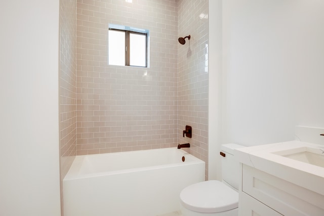 full bathroom with vanity, tiled shower / bath combo, and toilet