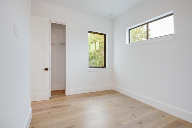 unfurnished bedroom featuring a closet and light hardwood / wood-style flooring