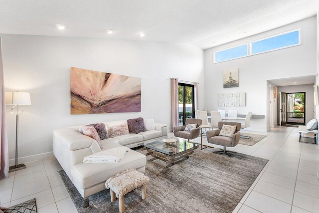 living room with light tile patterned flooring, a textured ceiling, and high vaulted ceiling