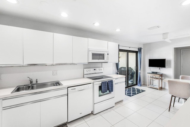 kitchen with white cabinetry, white appliances, sink, and light tile patterned floors