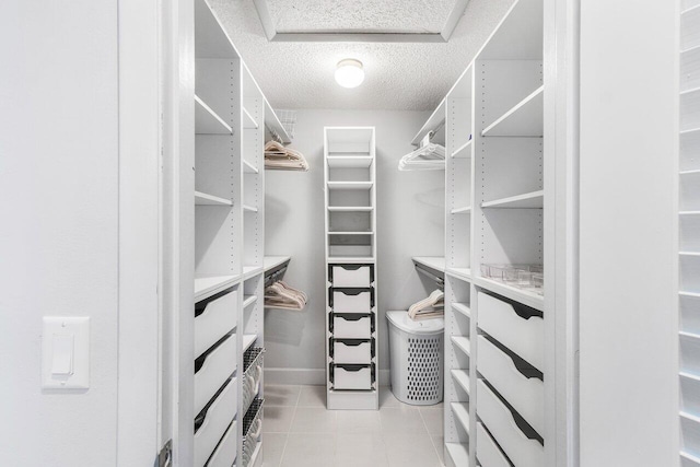 spacious closet with light tile patterned floors