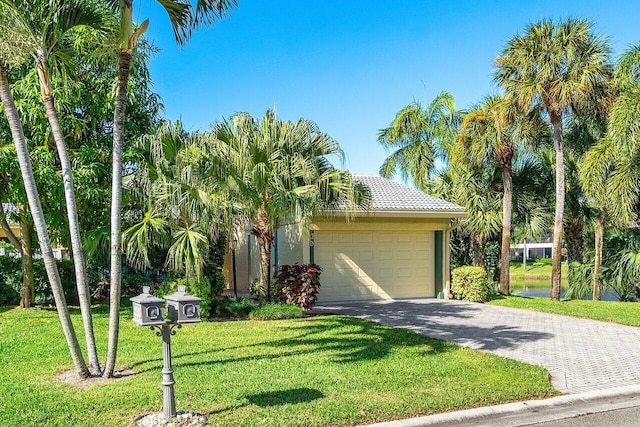 view of front of house with a garage and a front yard