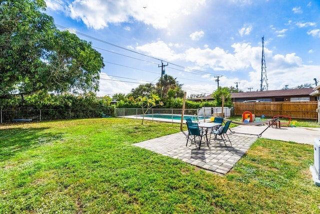 view of yard with a fenced in pool and a patio area