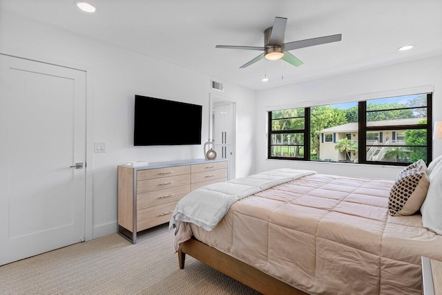 bedroom featuring ceiling fan and light colored carpet