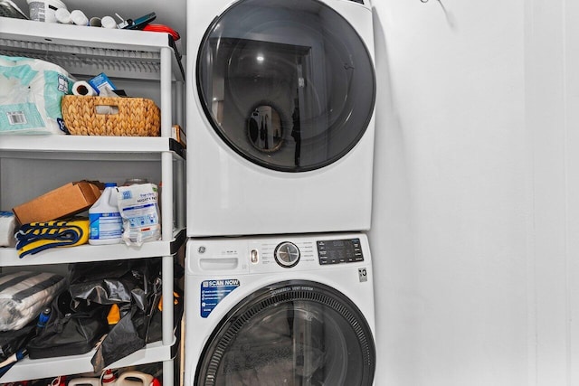 clothes washing area with stacked washer / drying machine