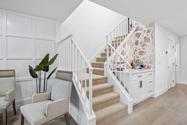 stairs featuring wood-type flooring