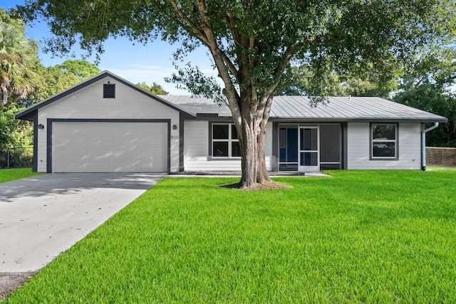 single story home with a front yard and a garage