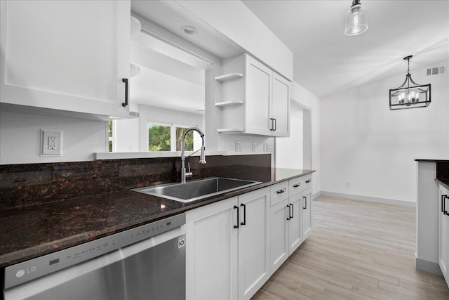 kitchen featuring light wood-type flooring, stainless steel dishwasher, sink, decorative light fixtures, and white cabinets