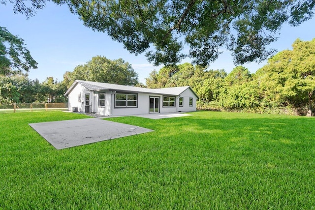 back of house with a patio area and a yard