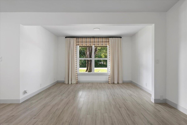 spare room featuring light hardwood / wood-style floors