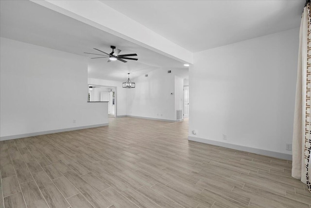 810 Bradley St, Fort Pierce, FL 34982 - unfurnished living room with light wood-style floors, a ceiling fan, baseboards, and a chandelier