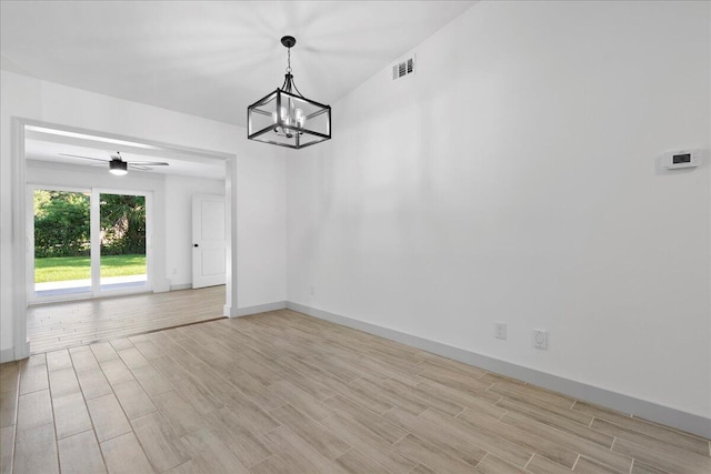 unfurnished dining area with light hardwood / wood-style floors and ceiling fan with notable chandelier