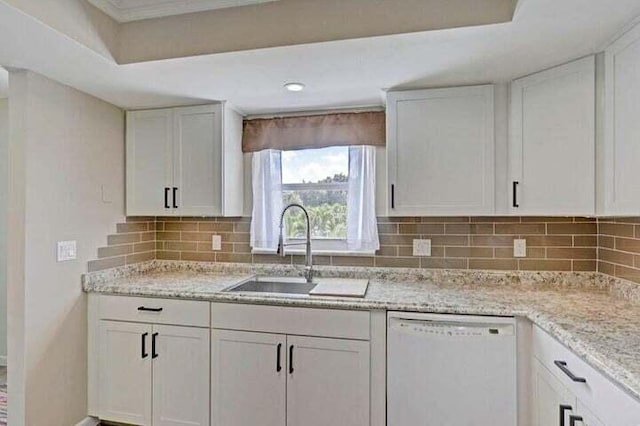 kitchen with white cabinetry, dishwasher, light stone countertops, sink, and tasteful backsplash