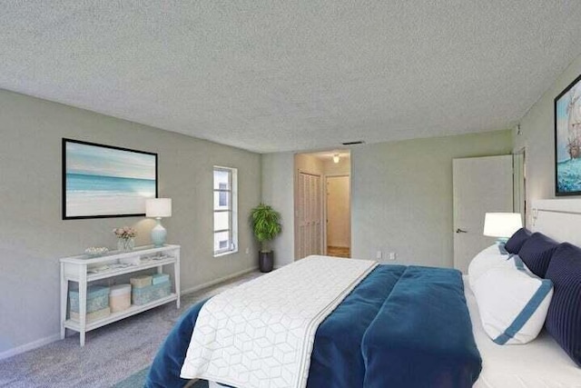 bedroom with carpet floors and a textured ceiling