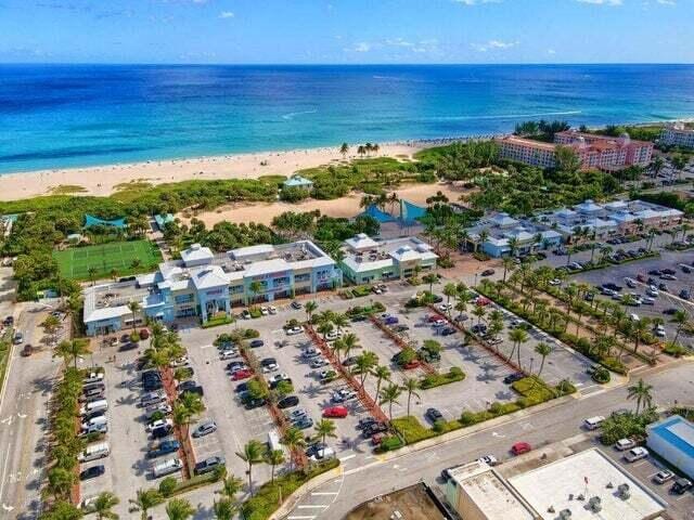 bird's eye view featuring a view of the beach and a water view