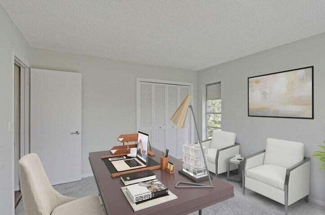 carpeted office featuring a textured ceiling