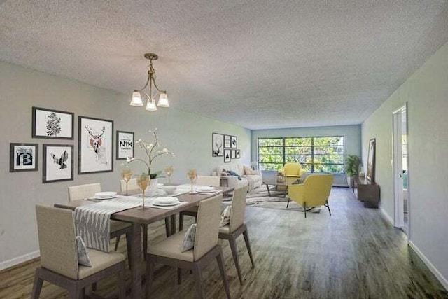 dining area with hardwood / wood-style floors, a textured ceiling, and a notable chandelier