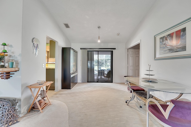 interior space featuring light colored carpet and vaulted ceiling