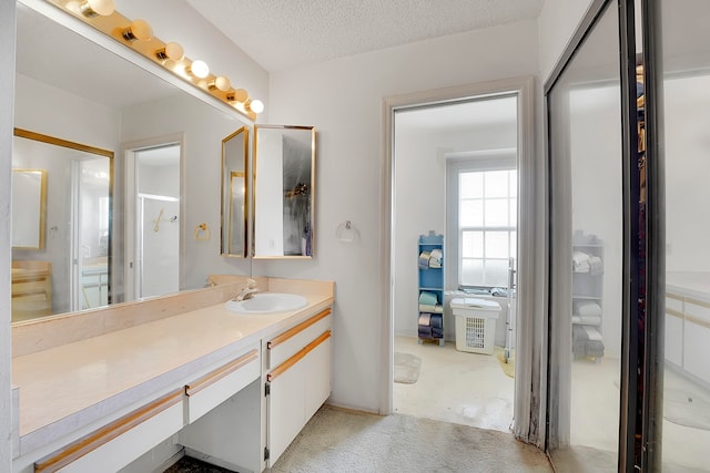 bathroom with vanity, concrete floors, and a textured ceiling