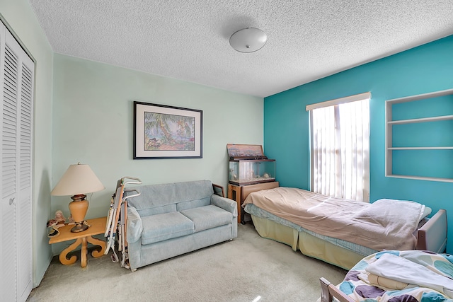 bedroom featuring a closet, carpet, and a textured ceiling