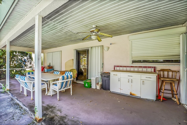 view of patio with an outdoor bar and ceiling fan