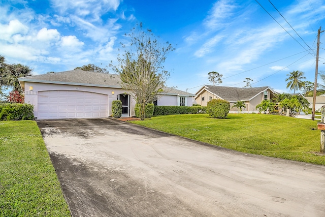 single story home featuring a front lawn and a garage