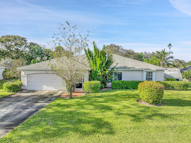 ranch-style home featuring a garage and a front lawn