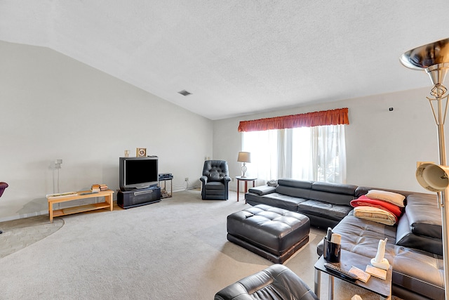 carpeted living room with a textured ceiling and vaulted ceiling