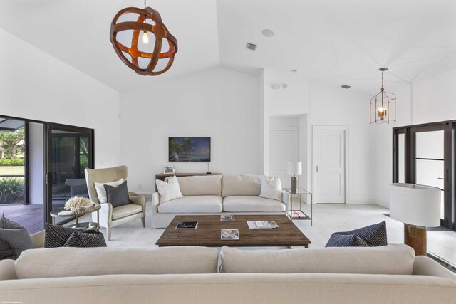 dining room with vaulted ceiling and a notable chandelier