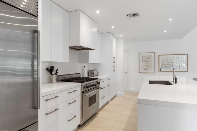 kitchen featuring stainless steel appliances, light countertops, visible vents, white cabinets, and a sink