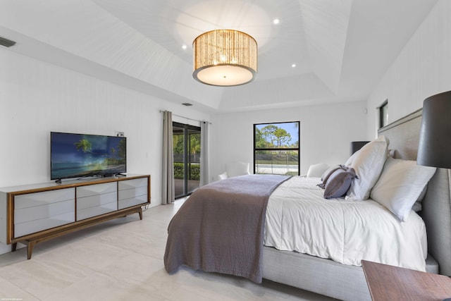 bedroom with a tray ceiling, access to outside, and recessed lighting