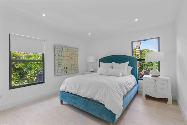 bedroom featuring recessed lighting, baseboards, and light tile patterned floors