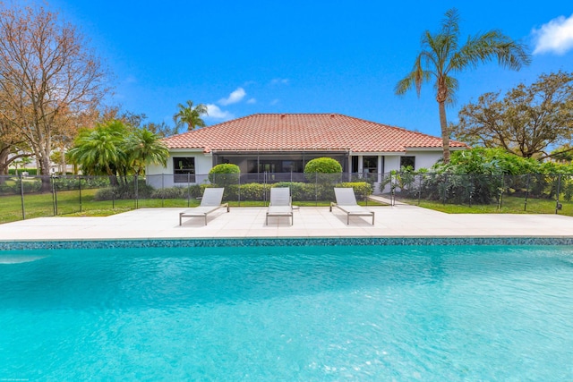 view of swimming pool featuring fence, a fenced in pool, and a patio