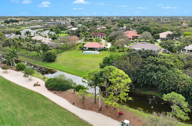 birds eye view of property with a water view and a residential view