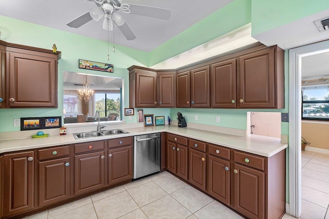 kitchen with ceiling fan with notable chandelier, sink, light tile patterned floors, dishwasher, and hanging light fixtures