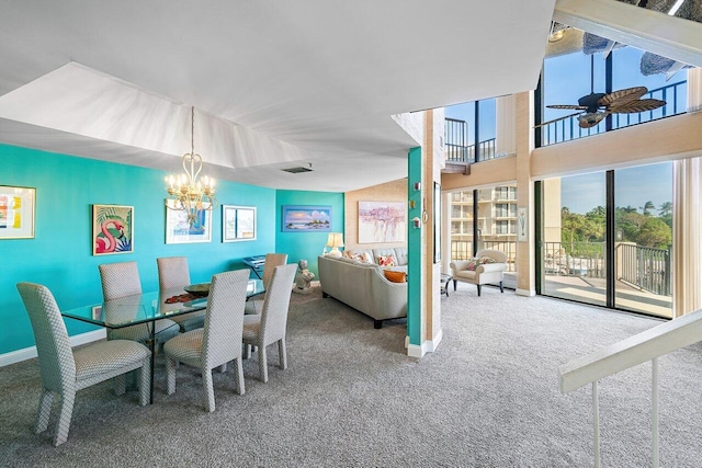 carpeted dining room with ceiling fan with notable chandelier