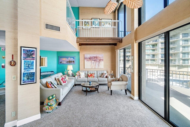 carpeted living room featuring a high ceiling