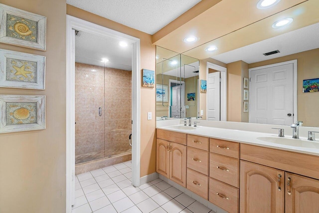 bathroom featuring tile patterned floors, vanity, and an enclosed shower