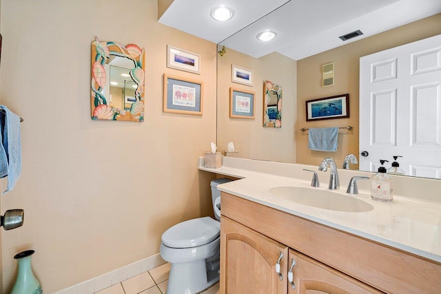 bathroom featuring tile patterned floors, vanity, and toilet